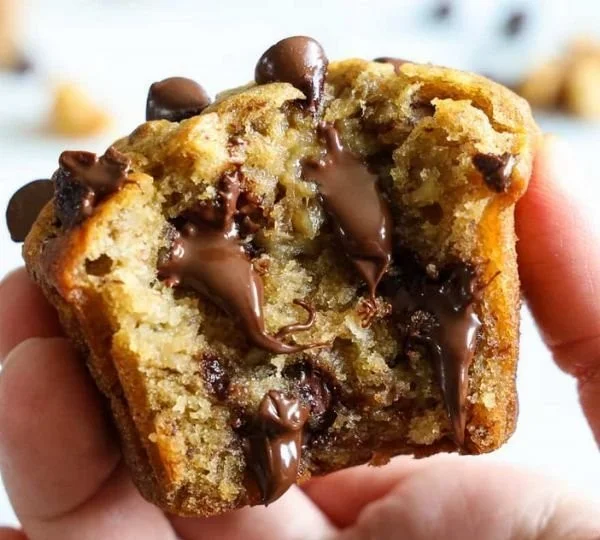 Freshly baked banana chocolate chip muffins on a cooling rack.