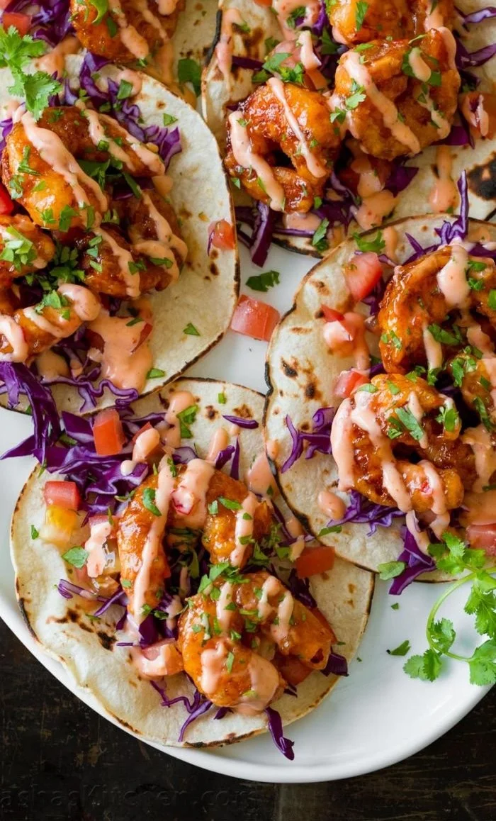 Delicious Bang Bang Shrimp Taco topped with creamy sauce and fresh ingredients