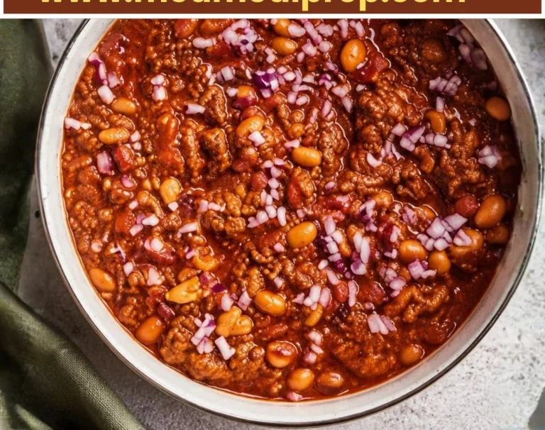 Thick and hearty beef chili in a rustic bowl topped with fresh herbs