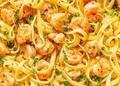Delicious garlic butter shrimp pasta in a white bowl with parsley garnish.