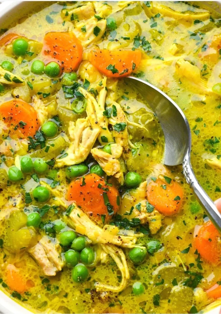 Bowl of healing turmeric chicken soup with herbs and spices