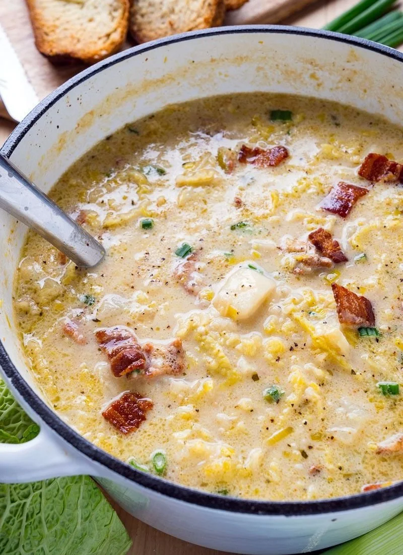 Bowl of Irish Potato and Cabbage Soup with Bacon topped with herbs