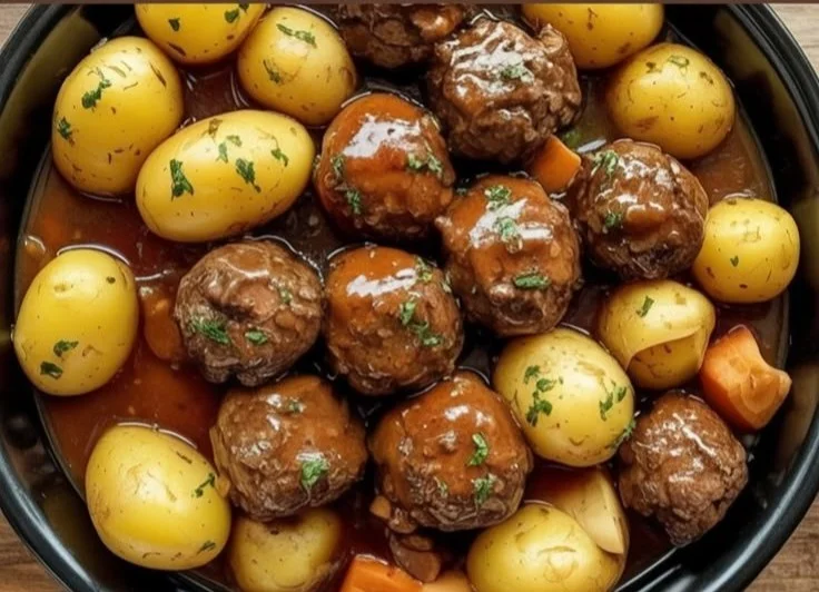 Slow Cooker Garlic Butter Beef Bites served on a plate with herbs and spices.