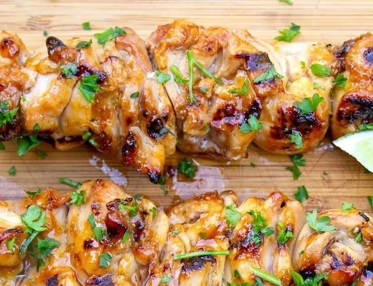 Spicy Honey Lime Chicken garnished with fresh lime and herbs