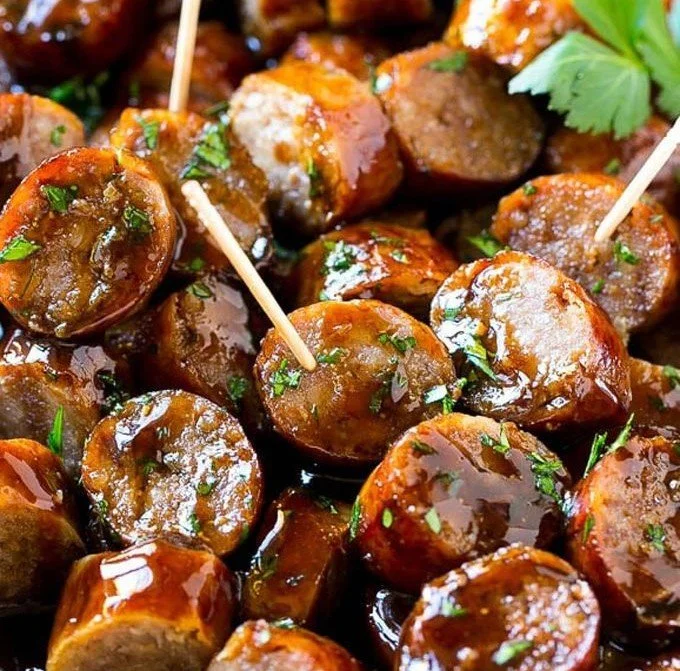 Delicious Beer Brat Bites served on a platter with dipping sauce