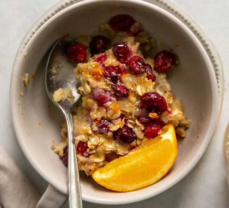 Baked oatmeal with cranberries and oranges served in a bowl
