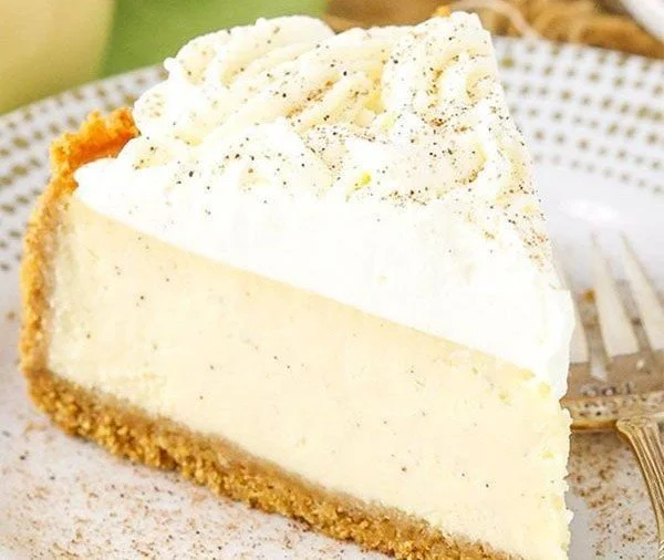 Delicious creamy eggnog cheesecake topped with festive decorations