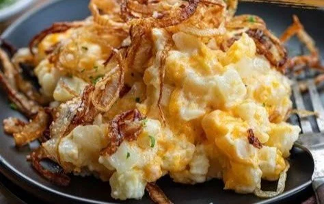 Creamy French onion potato casserole dish garnished with herbs