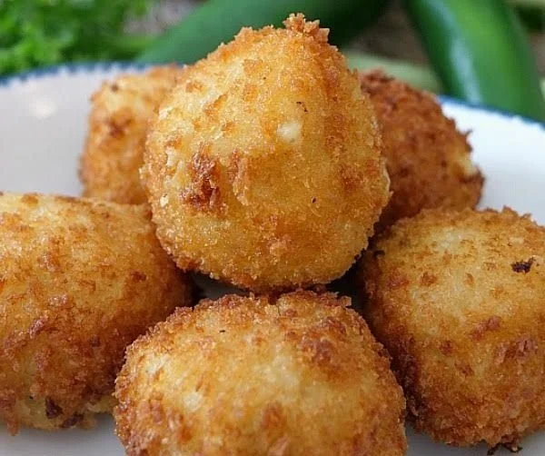 Crispy fried mashed potato bites served with dipping sauce