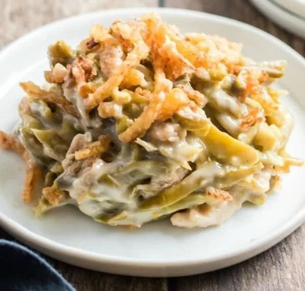 Delicious easy green bean casserole topped with crispy onions in a baking dish.