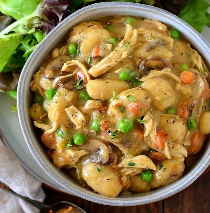 Easy one-pot chicken pot pie gnocchi in a creamy sauce and topped with herbs