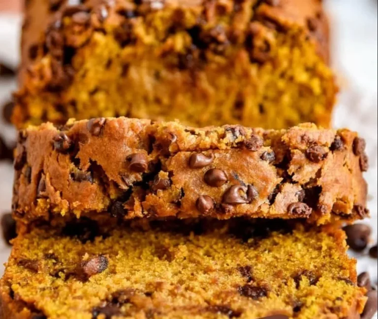 Slice of easy pumpkin bread with chocolate chips on a wooden cutting board