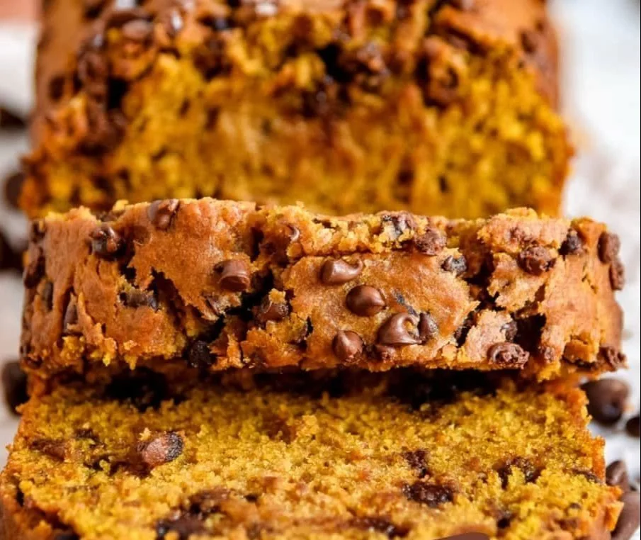 Slice of easy pumpkin bread with chocolate chips on a wooden cutting board