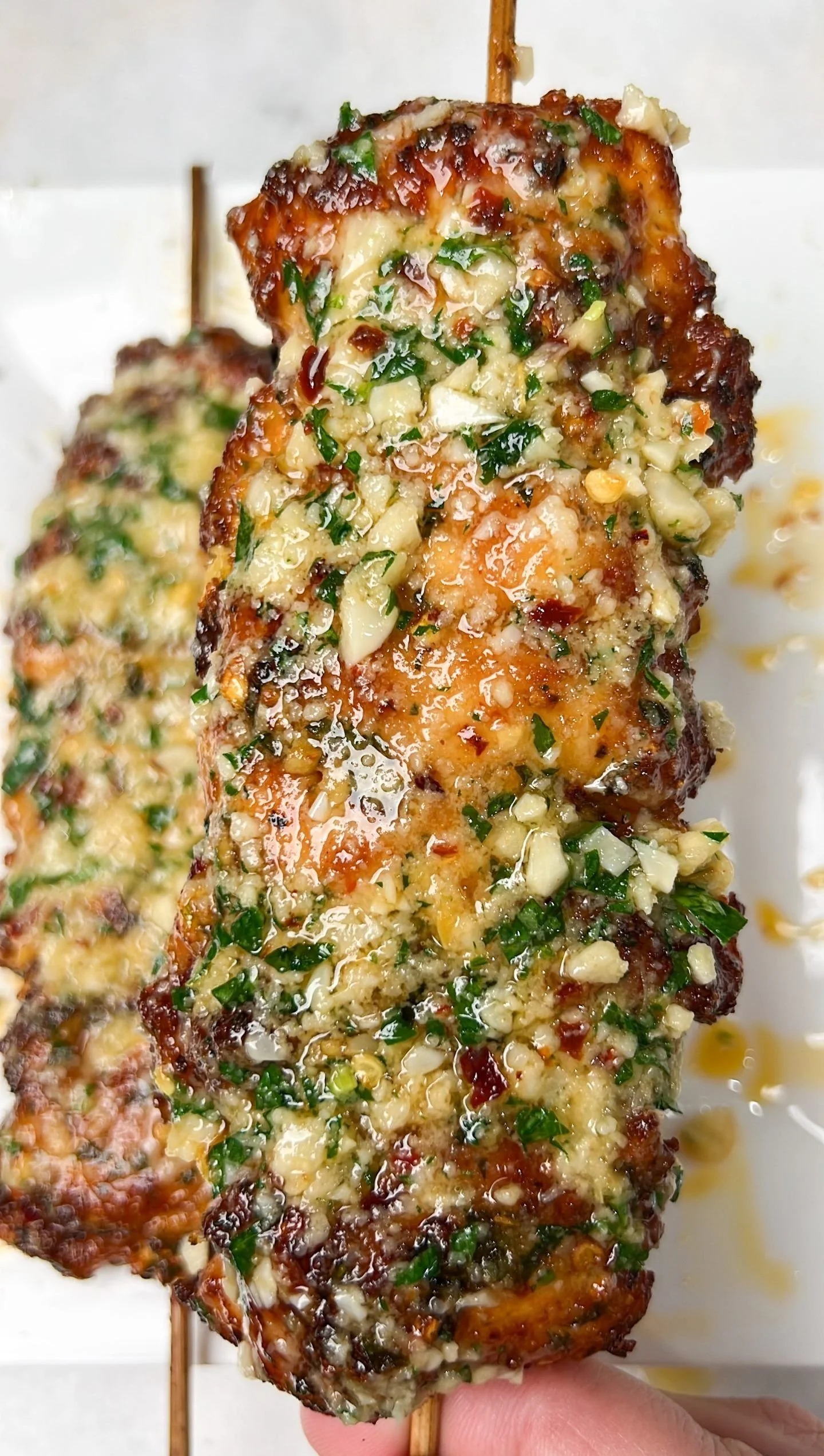 Grilled Garlic Parmesan Chicken Skewers garnished with herbs