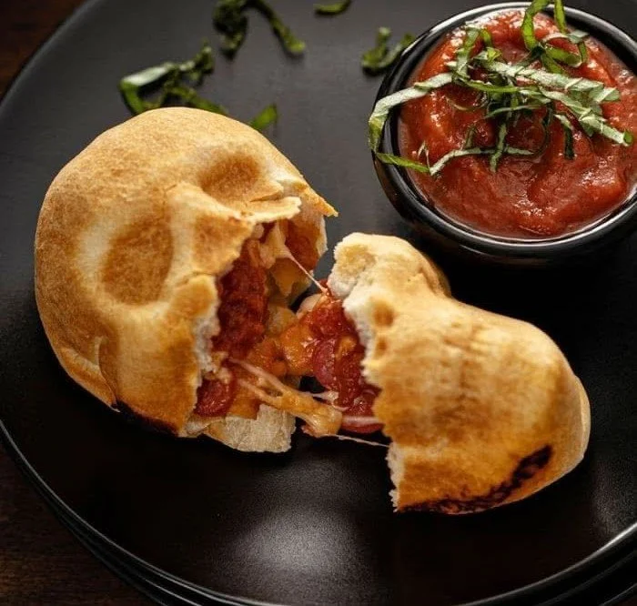 Halloween-themed pizza skulls ready to delight and scare on a spooky night.