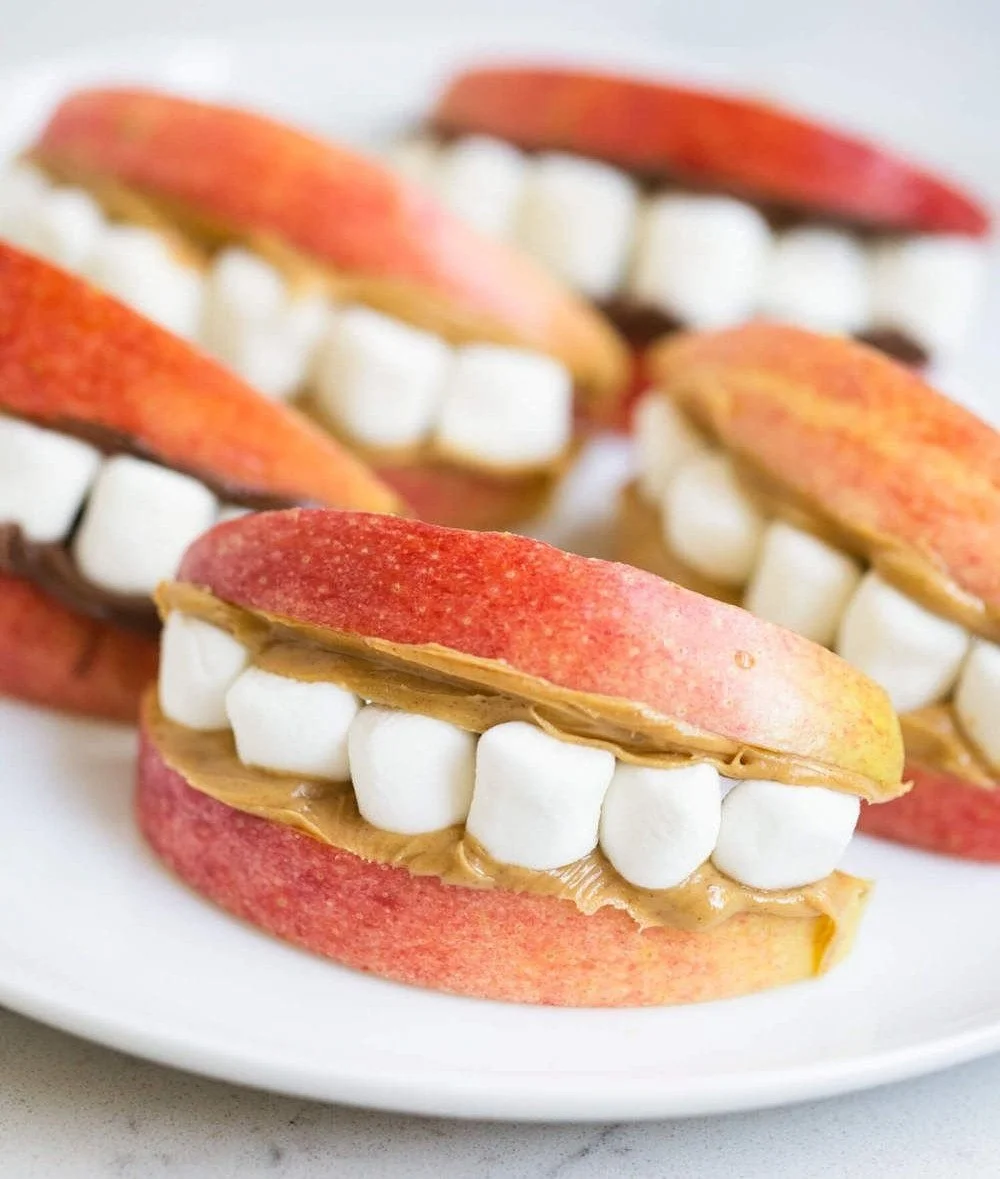 Assorted healthy Halloween snacks including fruit and veggie treats