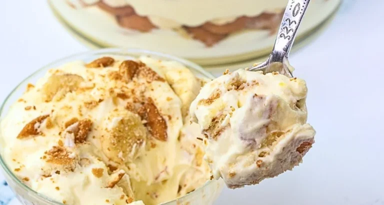Magnolia Bakery banana pudding served in a dish with whipped cream and banana slices