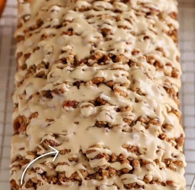 Loaf of freshly baked Maple Pumpkin Bread with a drizzle of maple glaze.