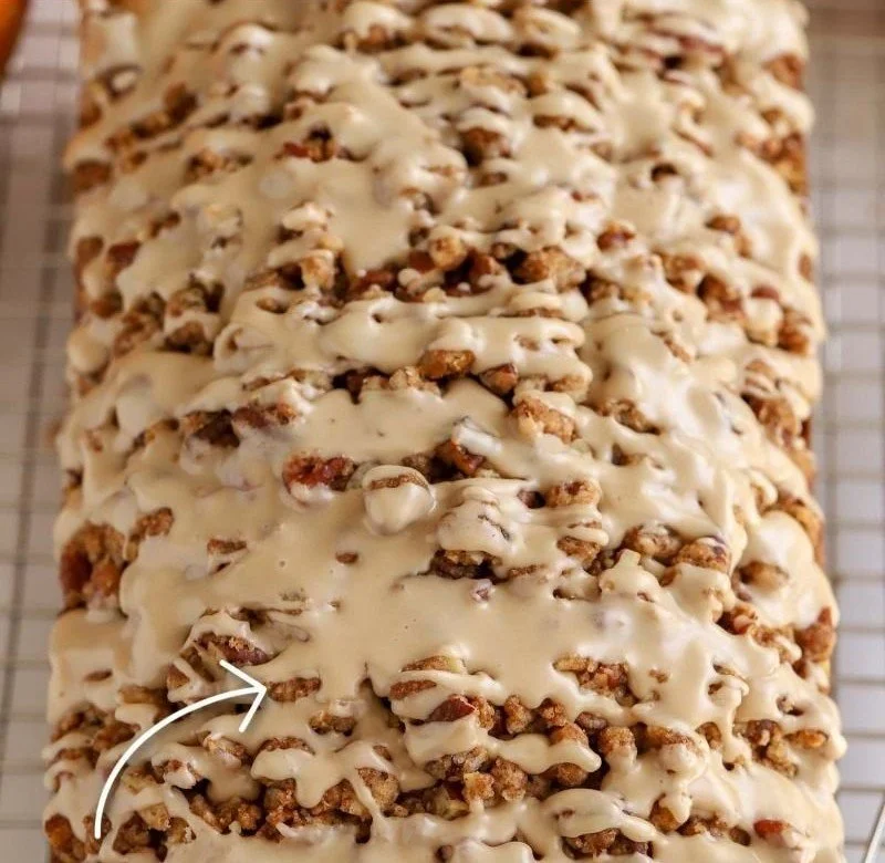Loaf of freshly baked Maple Pumpkin Bread with a drizzle of maple glaze.