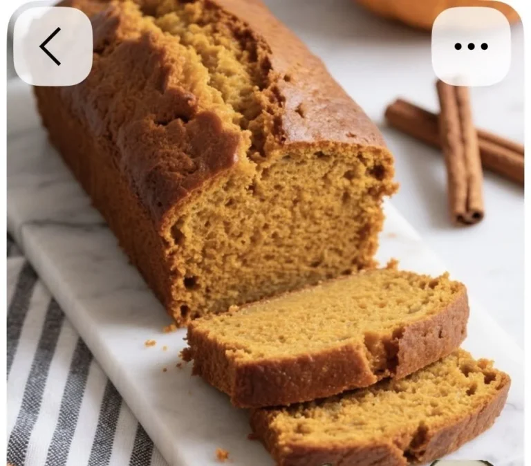 Slice of nut-free pumpkin bread on a plate with autumn decor