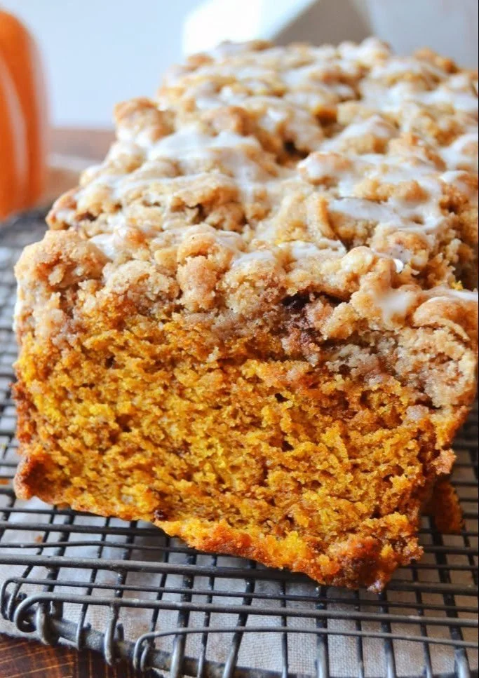 Slice of Pumpkin Apple Bread topped with streusel on a plate