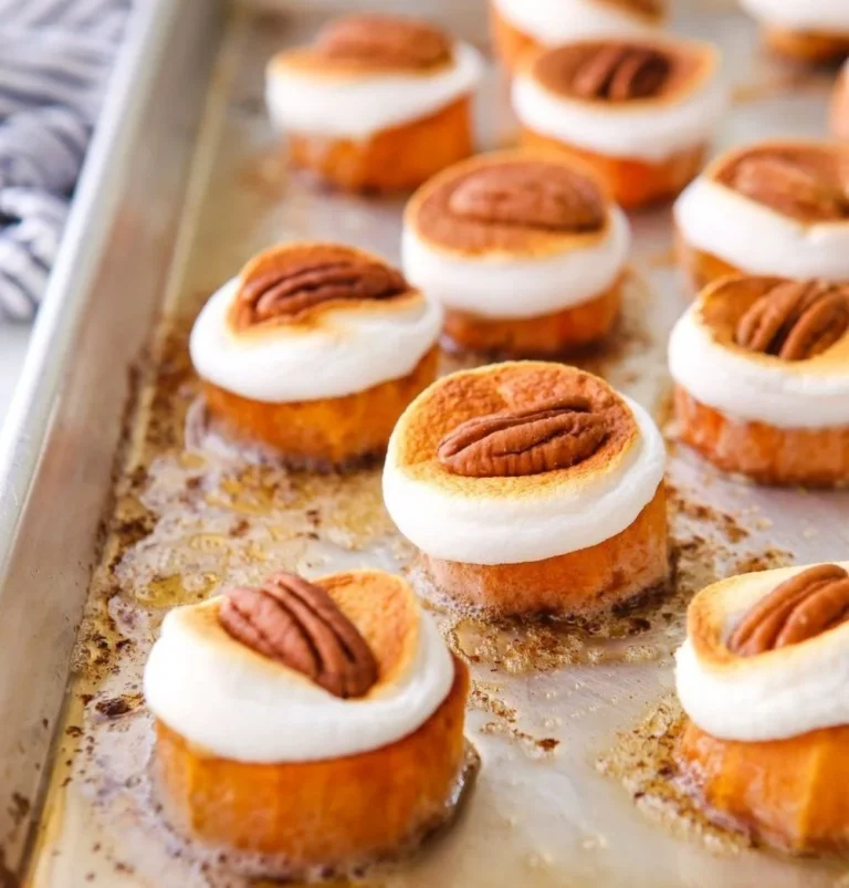 Sweet potato bites topped with marshmallows and pecans in a savory dish