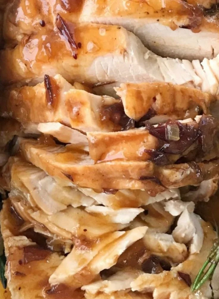Crockpot Turkey Breast with cranberry gravy served on a plate